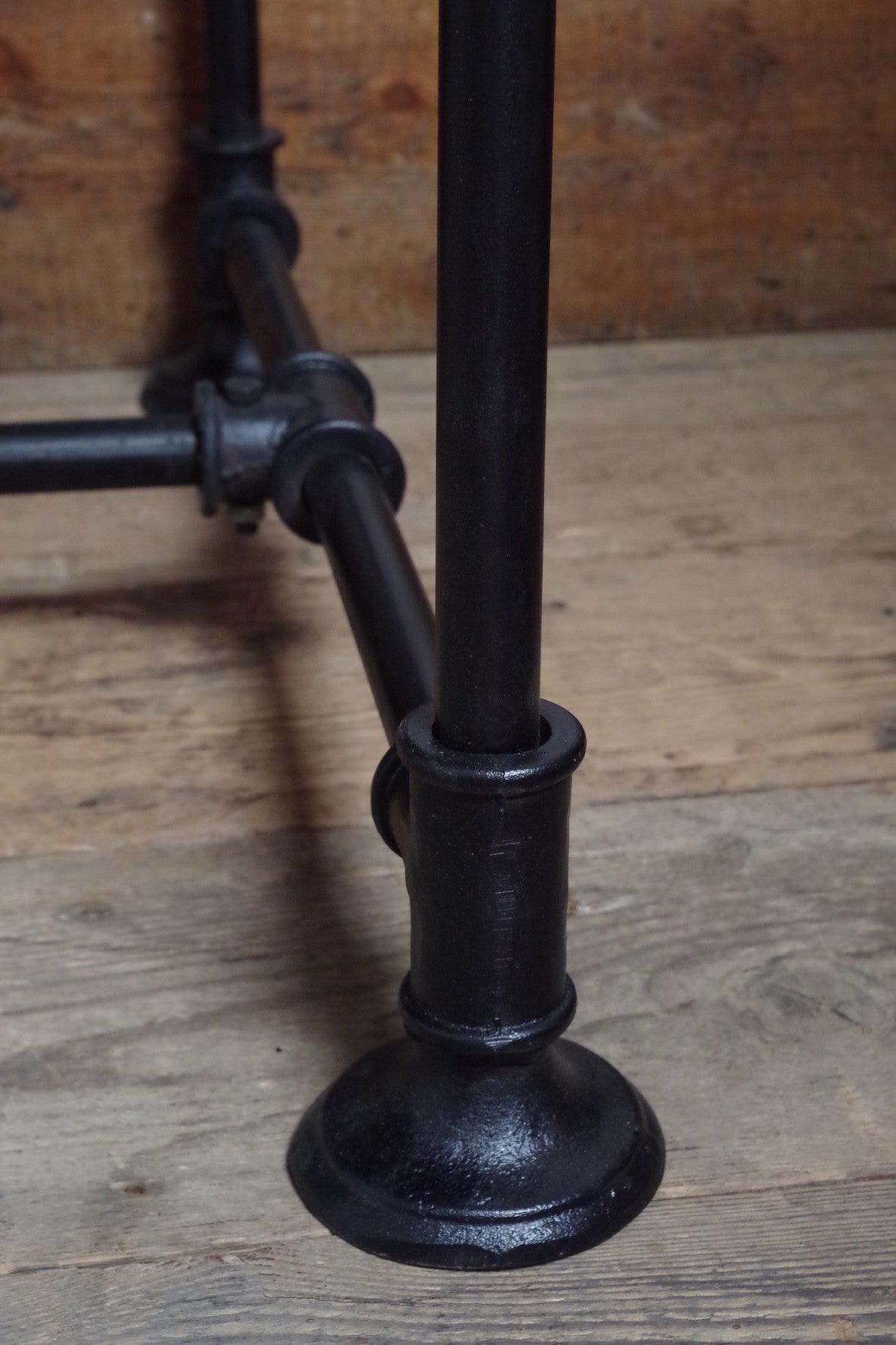 Industrial steampunk Desk with black metal legs and drawers and a wooden top.  